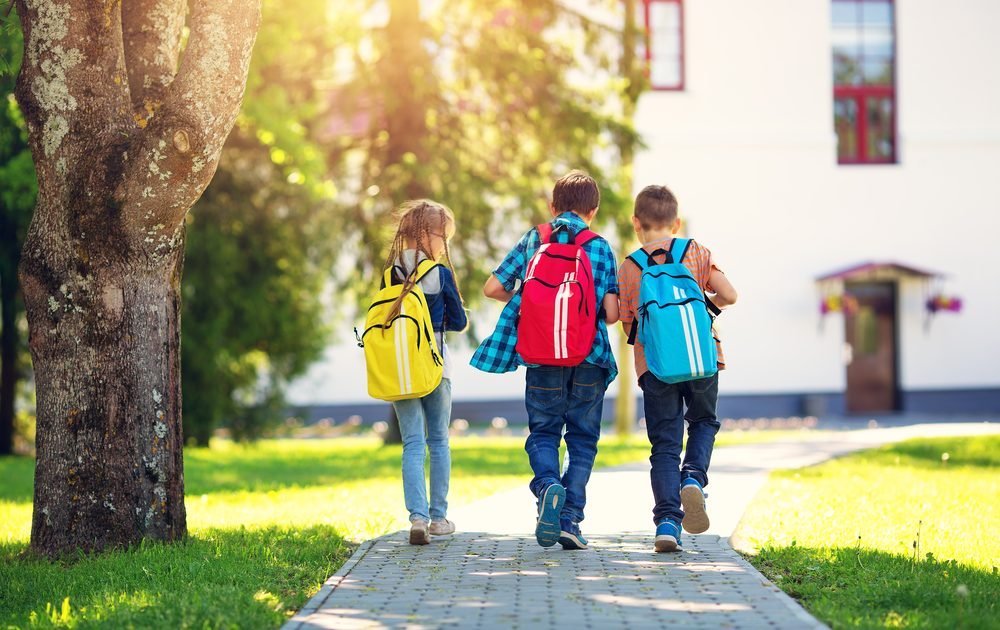 Kids with backpacks representing swapping textbooks for iPads