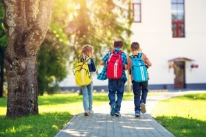 Kids with backpacks representing swapping textbooks for iPads