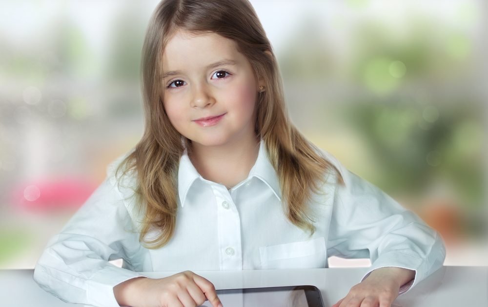 Girl with device representing iPad for education