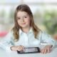 Girl with device representing iPad for education