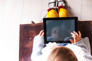 Child on iPad representing iPad use for dyslexic students